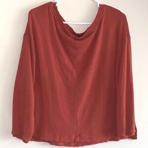 Free People burnt rust orange loose flowy raw hem semi cropped soft crew sweater